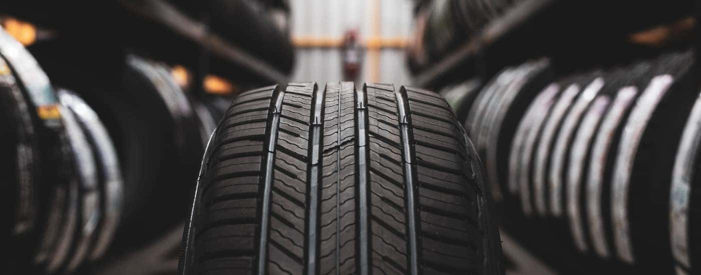 Two rows of tires are shown in a tire shop.