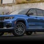A blue 2022 Jeep Grand Cherokee is shown from the front at an angle.