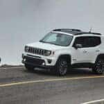 A white 2020 Jeep Renegade is shown from the side while rounding a corner after receiving brake service in Colorado Springs.