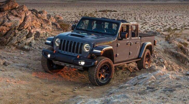 A grey 2021 Jeep Gladiator Mojave is shown from the front at an angle after leaving a dealer that has a Jeep Gladiator for sale near Gleneagle, CO.