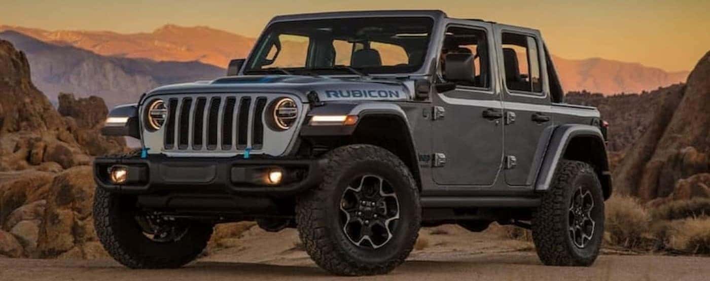 A gray 2021 Jeep Wrangler 4xe Rubicon is shown parked near a mountain.