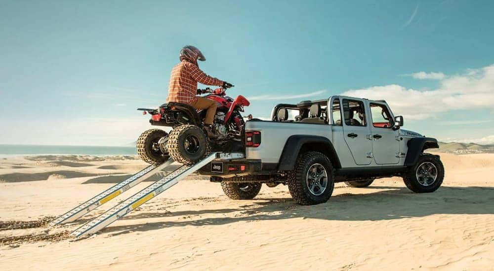 A white 2021 Jeep Gladiator Rubicon is shown from the rear at an angle.