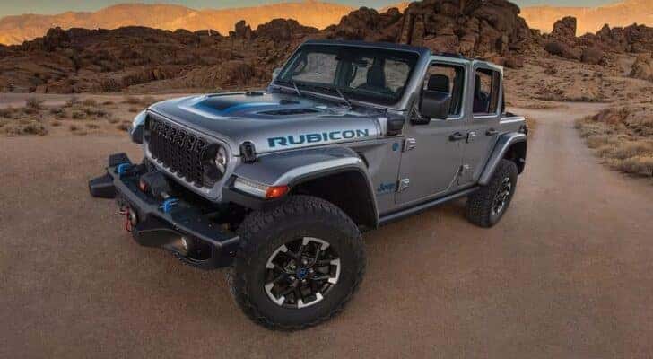 A silver 2024 Jeep Wrangler Rubicon 4xe is shown from the front at an angle.