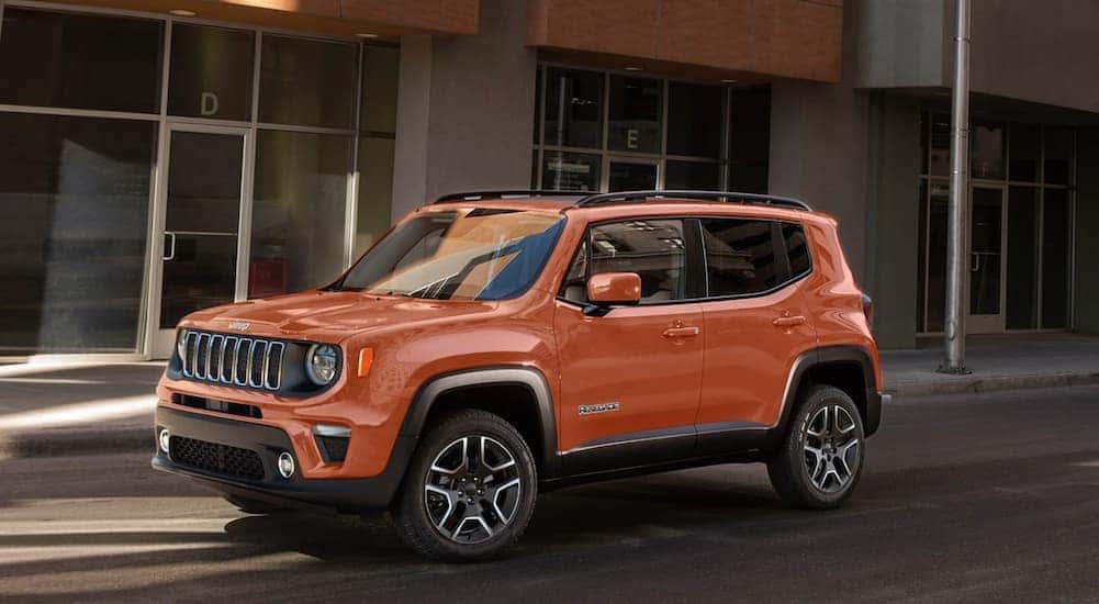 An orange 2020 Jeep Renegade is shown parked near used SUVs for sale.
