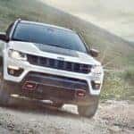 A white 2020 Jeep Compass Trailhawk is shown from the front at an angle after leaving a dealer where you can buy a used Jeep.