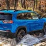 A blue 2022 Jeep Cherokee is shown from the rear at an angle.