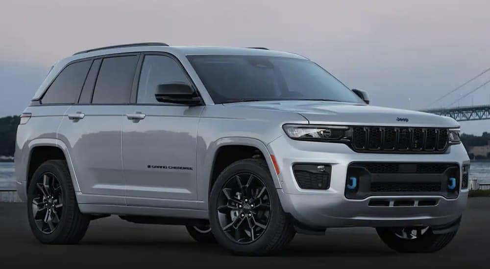 A silver 2023 Jeep Grand Cherokee 4xe is shown parked.