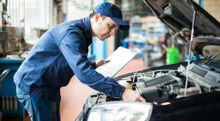 A mechanic is shown performing a multipoint inspection on a vehicle.