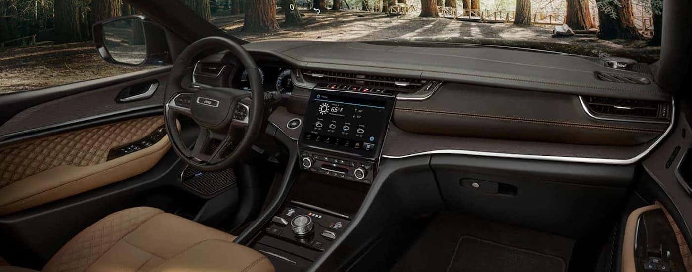 The brown leather interior of a 2022 Jeep Grand Cherokee WL for sale near Palmer Lake.