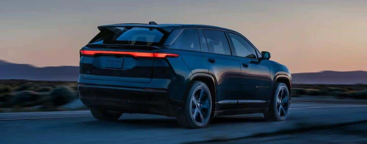A black 2024 Jeep Wagoneer S is shown driving at night.