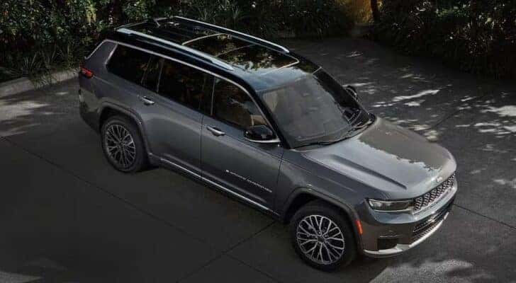 A gray 2023 Jeep Grand Cherokee L is shown parked on a driveway after viewing used Jeeps for sale near Peyton.