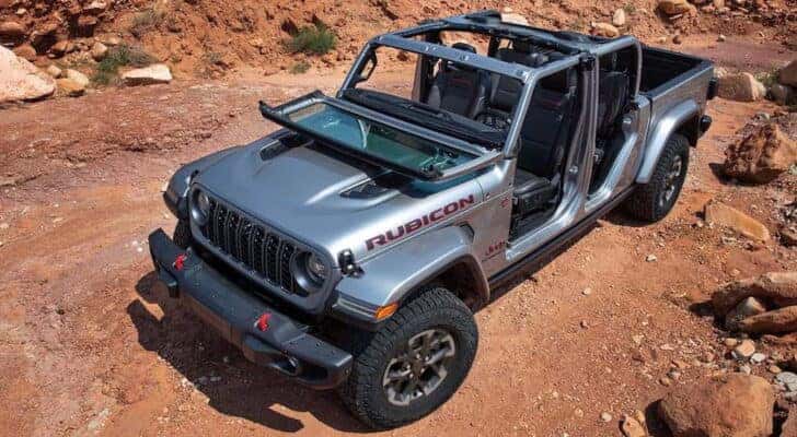 A silver 2024 Jeep Gladiator Rubicon is shown from the front at a high angle.