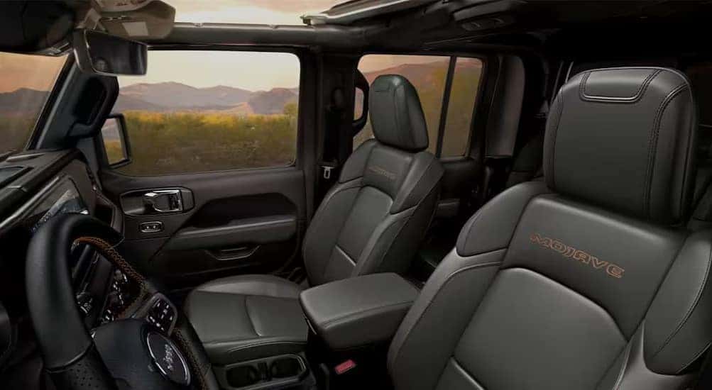 The black interior and dash are shown in a 2025 Jeep Gladiator Mojave.