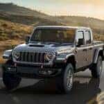 A silver 2025 Jeep Gladiator Mojave is shown driving after visiting a Jeep Gladiator for sale in Colorado Springs.