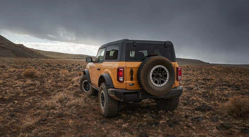 Rear view of a yellow 2022 Ford Bronco at a Colorado Springs used car dealer.