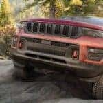 A red 2022 Jeep Grand Cherokee for sale in Colorado Springs from the front.