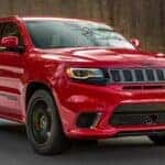 A red 2020 Jeep Grand Cherokee Trackhawk from the front.