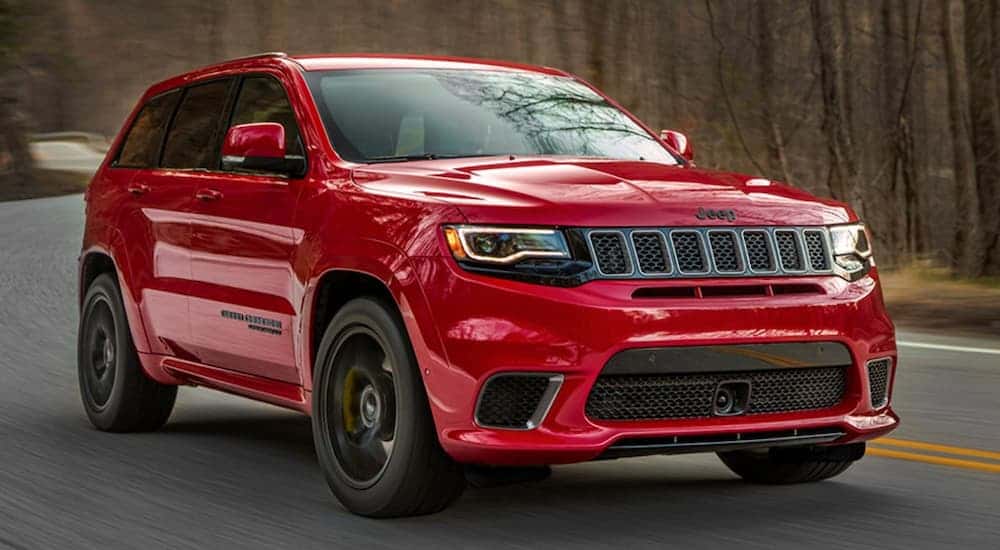 A red 2020 Jeep Grand Cherokee Trackhawk from the front.