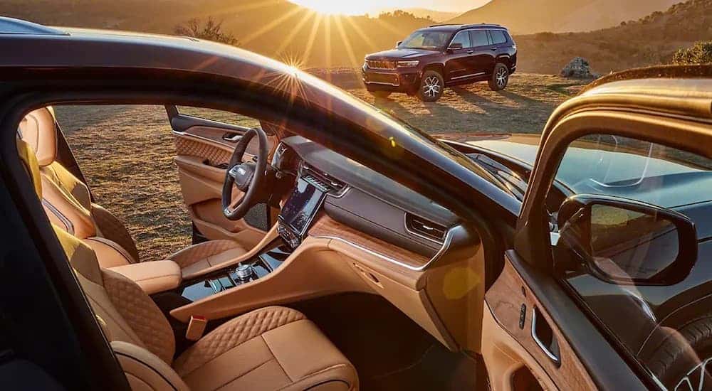 The tan interior of a 2022 Jeep Grand Cherokee from the passenger side.