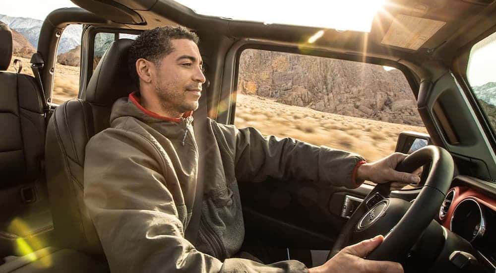 Interior shot of a man driving a 2025 Jeep Recon.