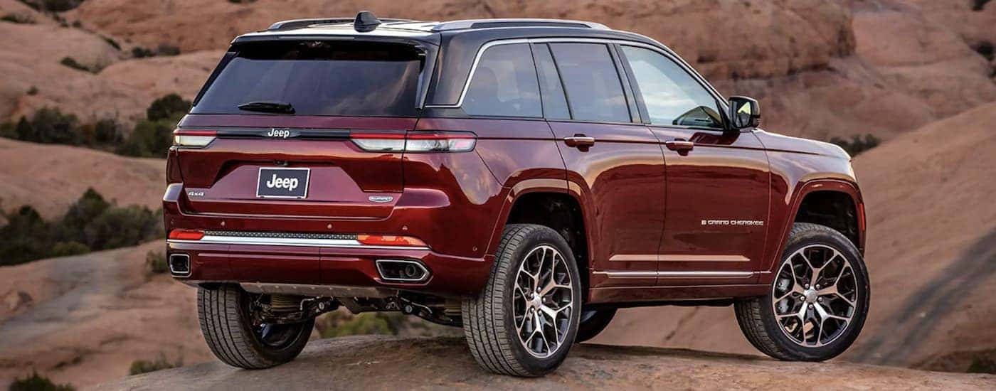 A red 2023 Jeep Grand Cherokee is shown parked after leaving a Denver Jeep dealer.