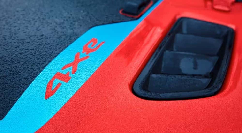 Red and blue 4x3 badge on the hood of a 2024 Jeep Wrangler 4xe