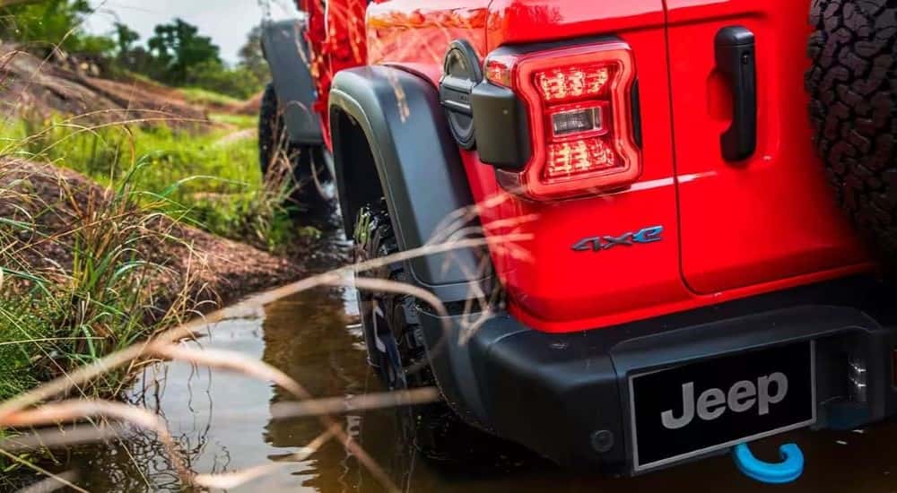 The rear taillights of a red 2024 Jeep Wrangler 4xe for sale in Colorado Springs