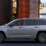 A silver 2023 Jeep Grand Cherokee L parked on a driveway.