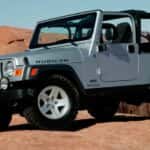 A used silver 2006 Jeep Wrangler for sale parked offroad.