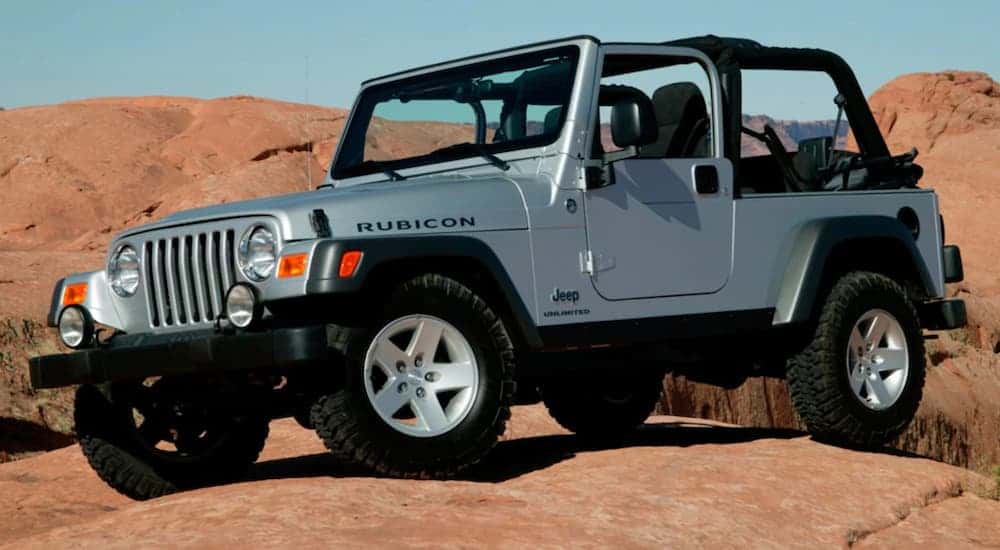 A used silver 2006 Jeep Wrangler for sale parked offroad.