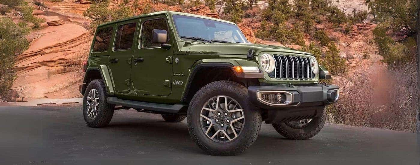 A parked used green 2024 Jeep Wrangler for sale.