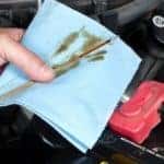 Service technician checking the oil in a vehicle