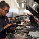 Mazda service technician inspecting a vehicle