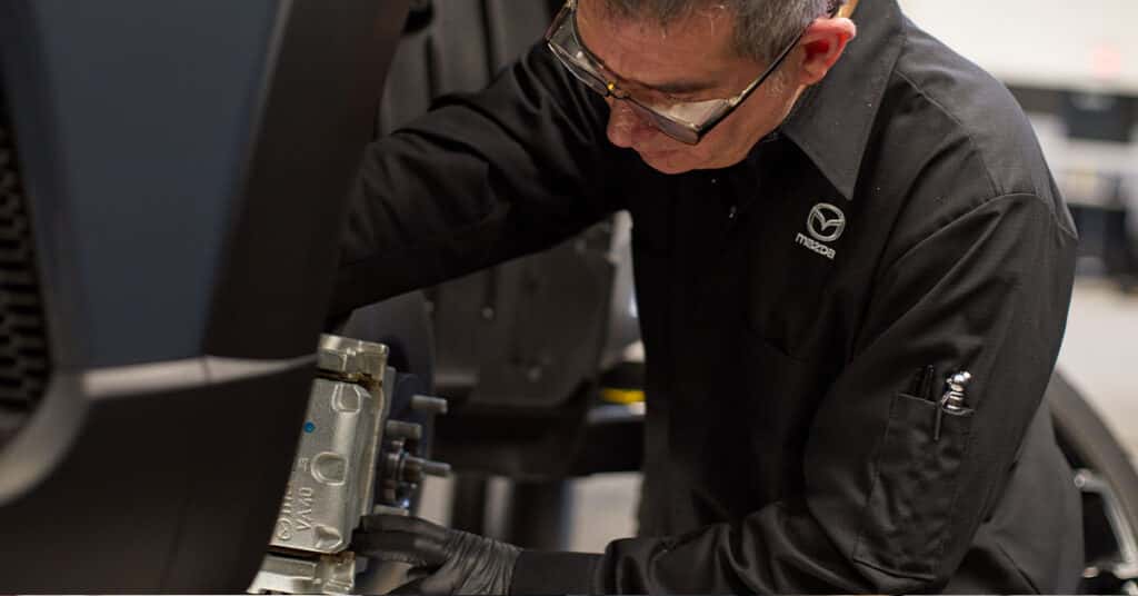Mazda service tech working on brakes