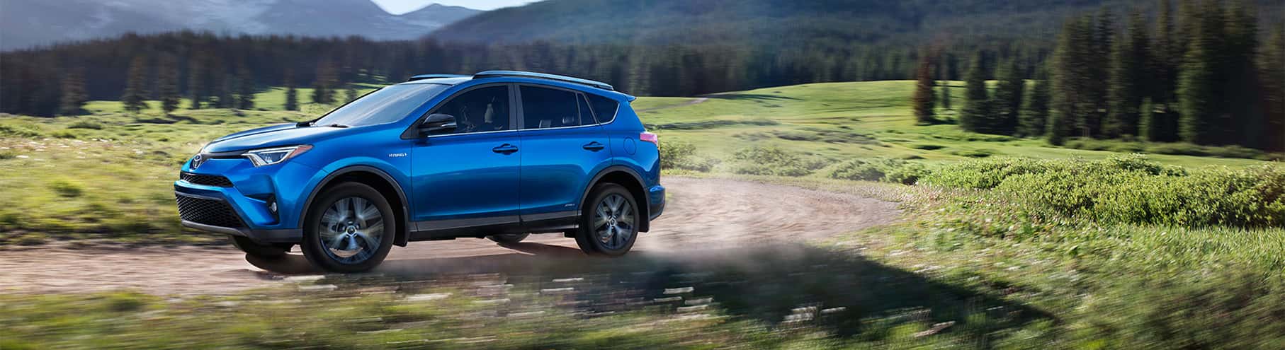Blue Toyota RAV4 Driving on Road