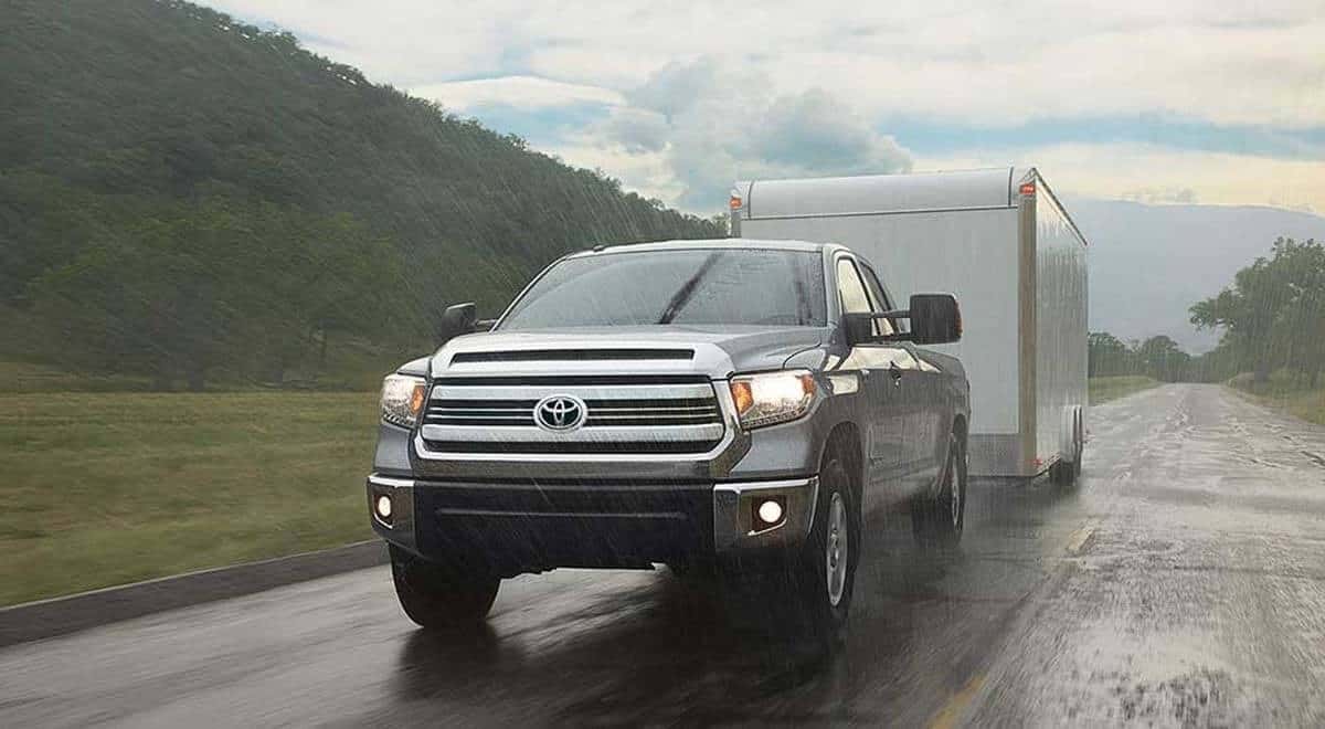 2017 Toyota Tundra driving in the rain pulling a trailer