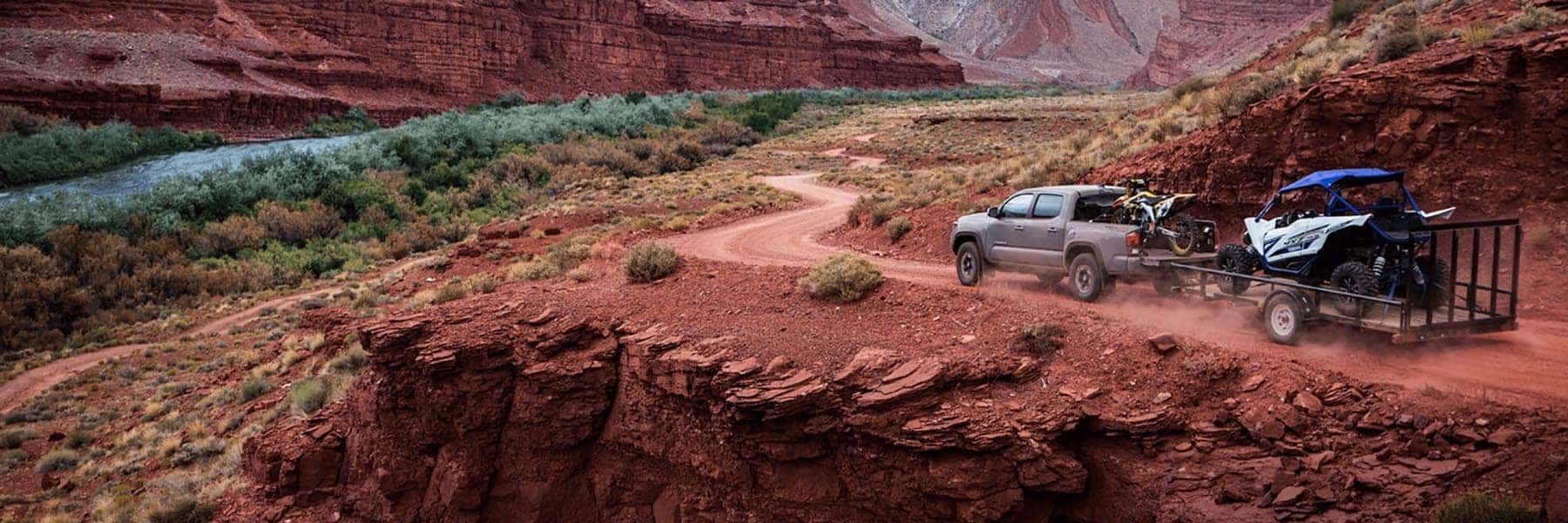 2018 Toyota Tacoma towing a trailer through the mountains