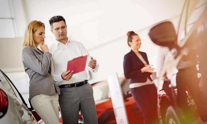Salesman showing customer car numbers