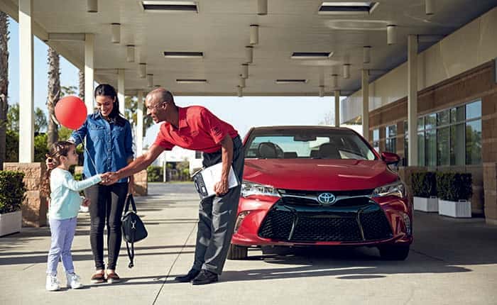 Woman leaving Toyota Dealer after Service