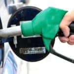 close up of hand pumping gas